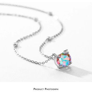 Macro shot of silver S925 necklace featuring a round colorful zircon in a four-claw setting
