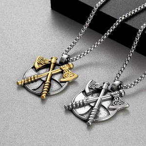 Detail view of vintage Viking axe pendants in silver and gold stainless steel