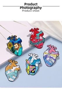Detailed close-up of five creative heart enamel pins featuring Van Gogh and ocean art