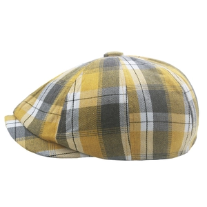 Detail of yellow and grey plaid newsboy cap with classic retro checkered pattern