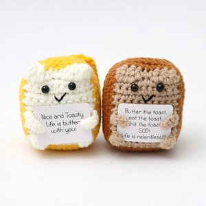 Macro detail of two crochet toast plushies with emotional support cards on white backdrop