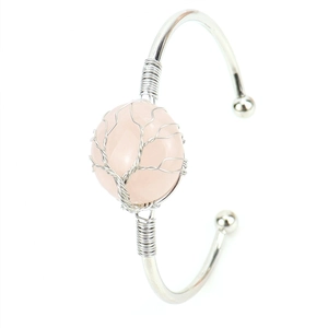 Detail of silver wire wrapped pink crystal rose quartz tree of life charm on open bangle