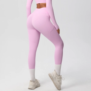 Detail of pink high-waisted yoga leggings showing lift effect and side functional pockets