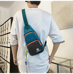 Detailed back view of a blue water-resistant crossbody chest bag with orange zipper accents