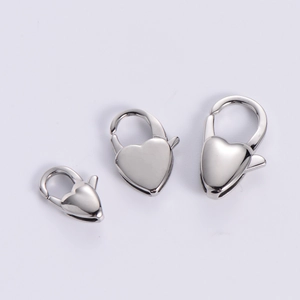 Detailed view of three polished heart-shaped lobster clasps in various sizes for jewelry