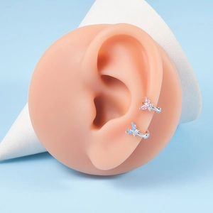 Detailed macro view of butterfly ear cuffs with pink and blue marquise cubic zirconia