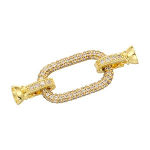 Macro shot of gold-plated jewelry connector with sparkling cubic zirconia inlay
