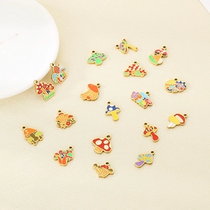 Close-up of 16 colorful enamel mushroom pendants with gold-plated borders on beige texture