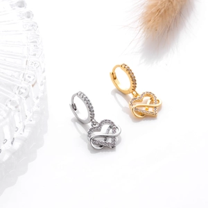 Detail of heart and infinity earrings in gold and silver with sparkling cubic zirconia