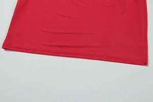 Detail of red dress hem with professional double-needle stitching and smooth knit fabric