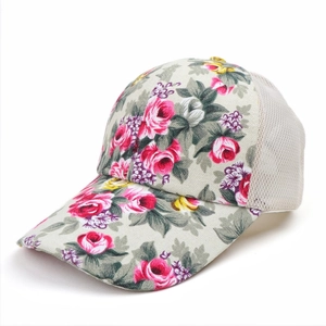 Detail of floral canvas texture and breathable mesh panels on a summer baseball cap