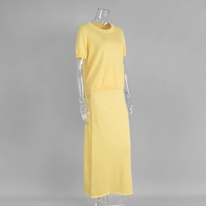 Detail view of light yellow knitted two-piece set showing premium fabric texture and drape