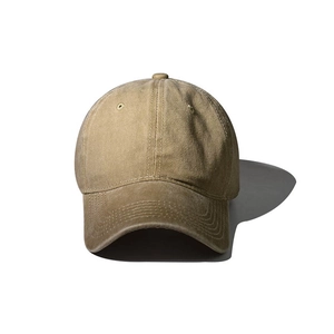 Detailed close-up of washed khaki cotton baseball cap showing stitch texture and air vents