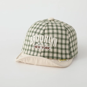 Detail of green gingham baby cap featuring Brooklyn New York 3D letter embroidery