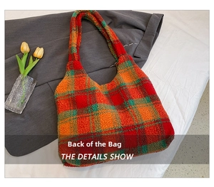 Detail view of fuzzy sherpa tote bag with orange and green plaid pattern texture
