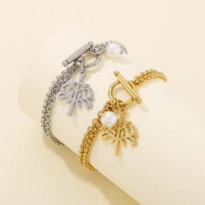 Detail of dual-layer tree of life bracelets with OT clasp in silver and gold finish