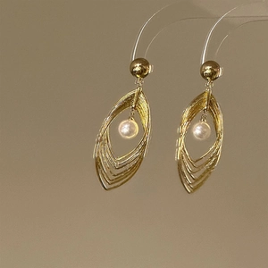 Golden multi-layer hollow leaf earrings with white pearls and brushed metal finish