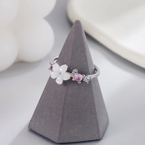 Minimalist S925 silver shell flower ring with pink gemstone and white zircon on a cone stand