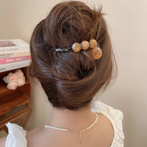 Nahaufnahme der Vintage-Haarklammer mit orangefarbenen Marmorperlen für Hochsteckfrisuren