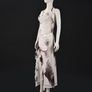Detail of mesh fabric with ink print on halter top and asymmetrical ruffle skirt