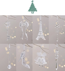 Close-up of clear acrylic Christmas ornaments including key, snowflake, and bell shapes