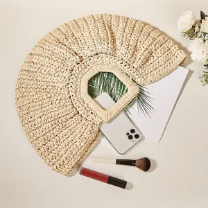 Handmade woven straw crescent beach bag with round top handles for summer vacations
