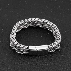 Macro detail of men's silver stainless steel wheat chain bracelet with a magnetic clasp