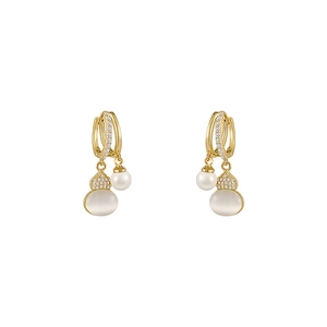 Golden gourd earrings with cat-eye stone and pearls on a clean white background