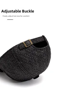 Close-up of bronze adjustable metal buckle on a black straw baseball cap for custom fit