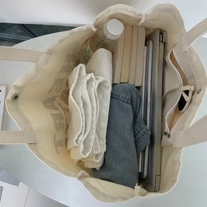 Top view of spacious canvas tote bag showing inner pockets and large storage capacity