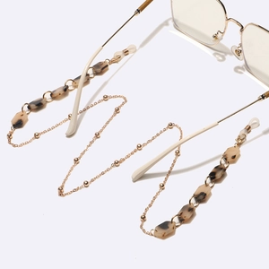Fashionable tortoise shell and pearl acetate eyeglass chain with gold metal link details