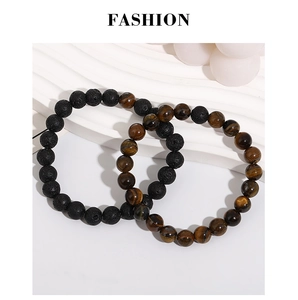 Detail view of natural volcanic stone and tiger eye bead bracelets on a white display
