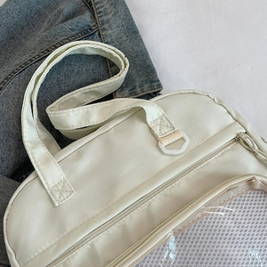 White canvas ita bag with reinforced webbing handles and transparent mesh layer detail
