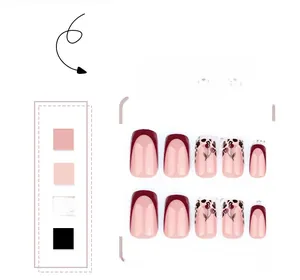 Détails de faux ongles rouges style French avec motifs cerise et accents léopard