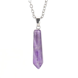 Macro shot of natural amethyst hexagonal prism pendant with silver chain detail