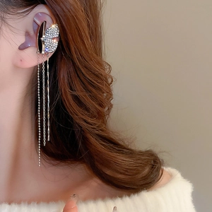 Detail of silver butterfly ear cuff with dangling rhinestone fringe on a model