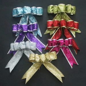 Set of seven glitter handmade Christmas tree bows in various vibrant metallic colors