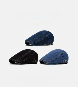 Detailed view of washed denim flat caps with adjustable brass buckle and contrast stitching