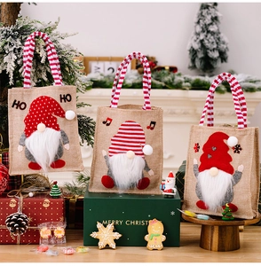 Three festive Christmas burlap gift bags featuring cute Rudolph and gnome plush designs