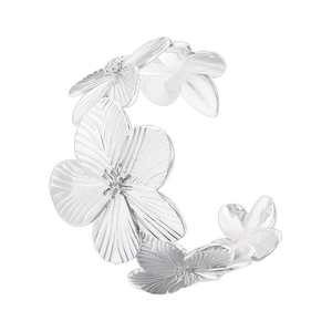 Macro shot of silver flower cuff bracelet with detailed brushed texture and open design