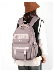 Detail view of the purple large capacity school backpack with multiple pockets and prints