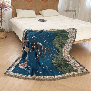 Bohemian woven picnic blanket with snake and stars pattern and colorful tassels