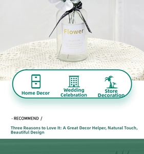 Detail of faux monstera leaf in glass vase with decorative ribbon for home wedding decor