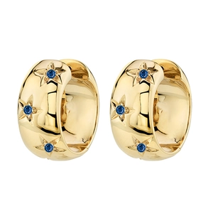 Gold huggie hoop earrings with engraved stars and blue zircon stones on white background