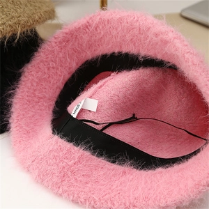 Detail of pink faux mohair bucket hat featuring internal sweatband and adjustable drawstring