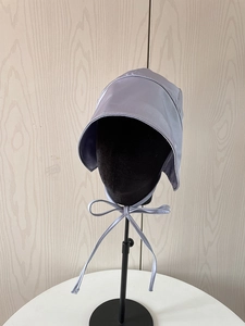 Detail view of purple satin sun hat with ribbon ties shown on a mannequin head