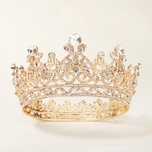 Close-up of golden bridal tiara featuring detailed sparkling crystals and rhinestones