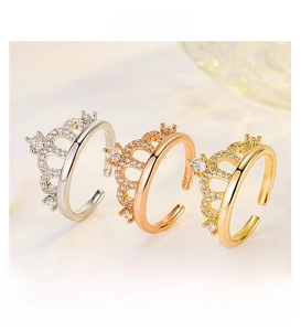 Detailed view of crown rings in silver, gold, and rose gold with zircon accents