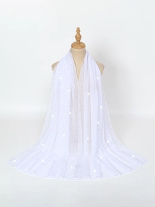 Detail of white semi-transparent chiffon shawl featuring elegant shimmering rhinestones