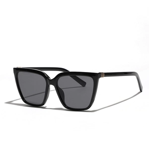 Fashionable square black oversized sunglasses with dark grey lenses and gold accents